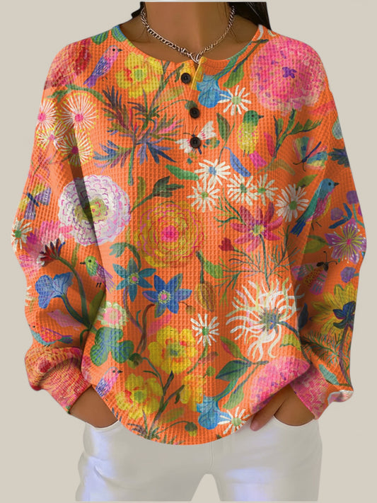 Faustine - Pull orange à motif floral coloré